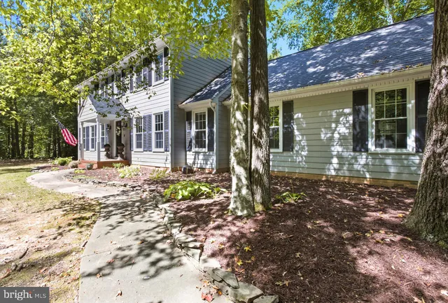 a front view of a house with a tree