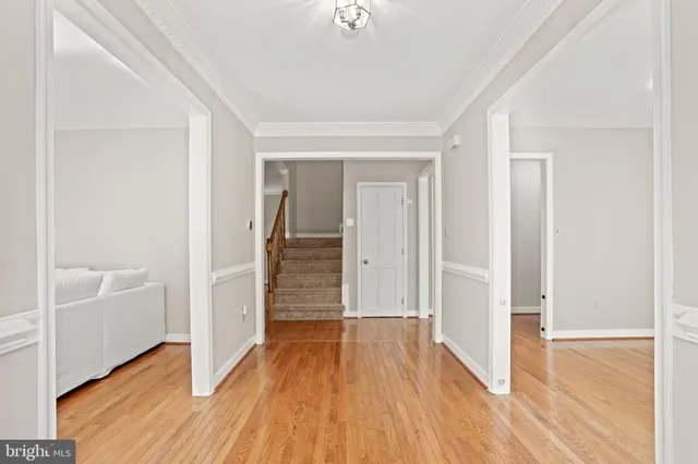 a view of a hallway with wooden floor