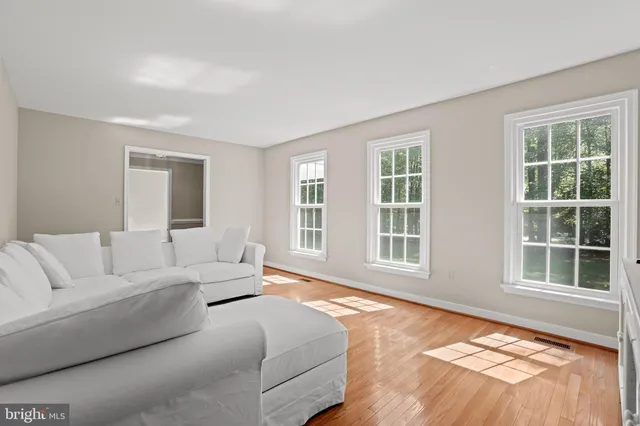 a spacious bedroom with a bed and a large window