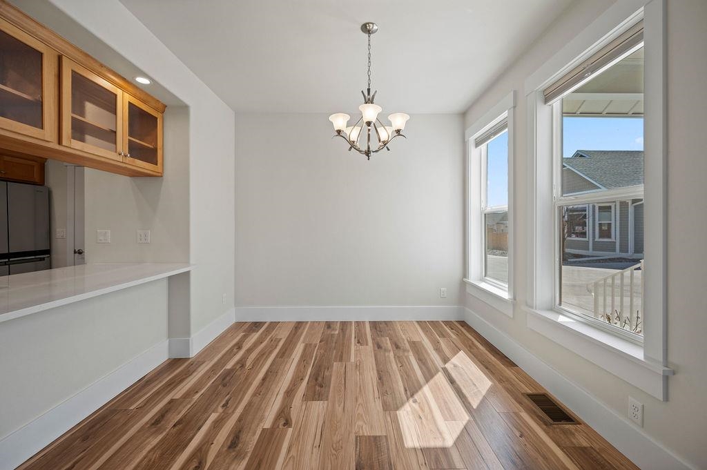 1243 Periwinkle Street Fruita, CO 81521 - Photo 11 of 24 a view of a room with wooden floor and windows