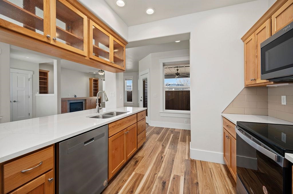 1243 Periwinkle Street Fruita, CO 81521 - Photo 14 of 24 a large kitchen with a stove and a sink
