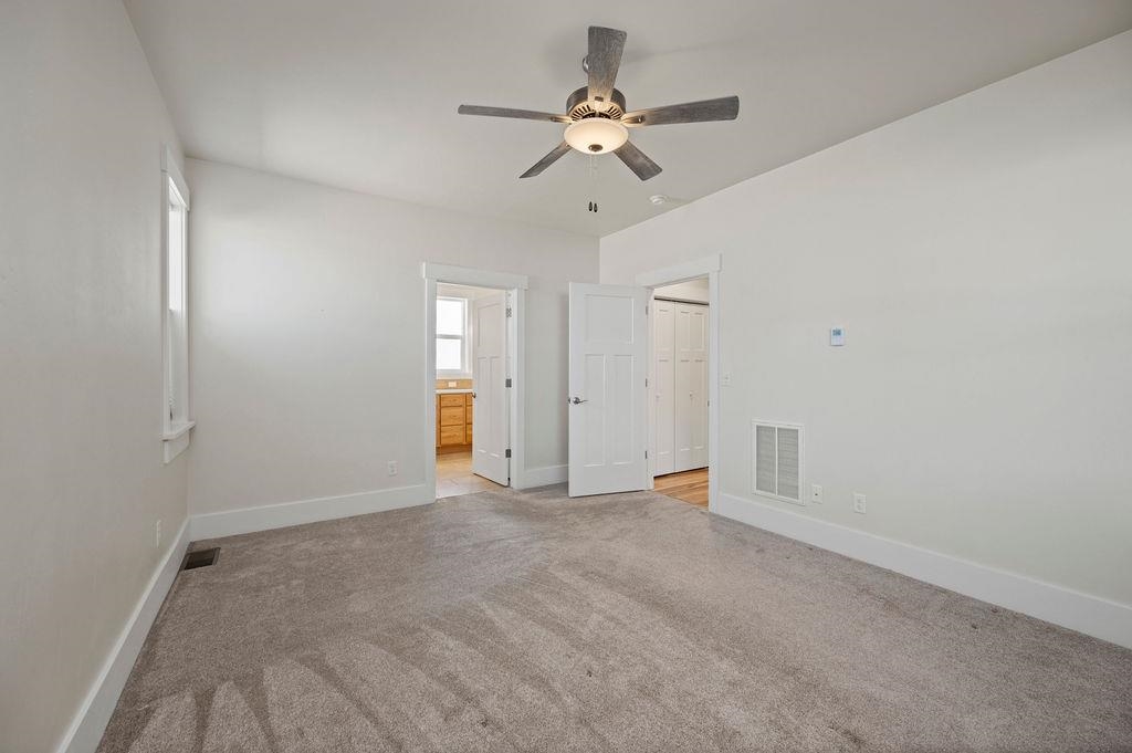 1243 Periwinkle Street Fruita, CO 81521 - Photo 16 of 24 a view of an empty room with a ceiling fan