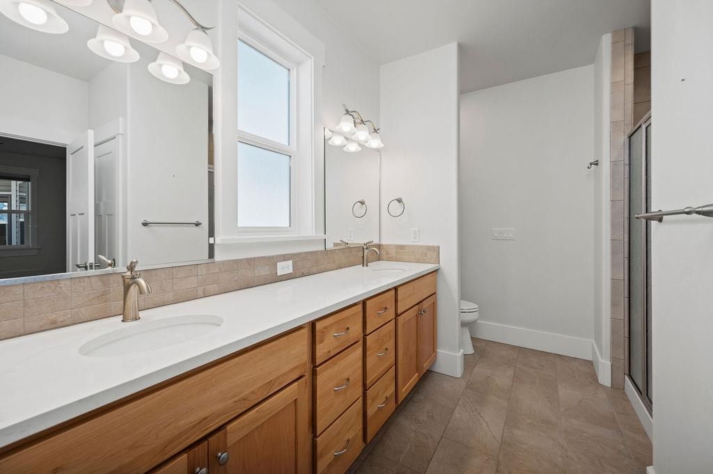 1243 Periwinkle Street Fruita, CO 81521 - Photo 17 of 24 a bathroom with a sink double vanity and a mirror