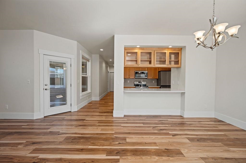 1243 Periwinkle Street Fruita, CO 81521 - Photo 7 of 24 a view of kitchen and hall with wooden floor