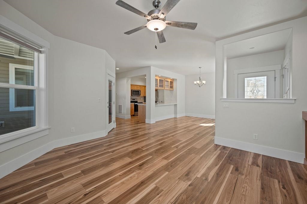 1243 Periwinkle Street Fruita, CO 81521 - Photo 10 of 24 a view of an empty room with a window and a kitchen