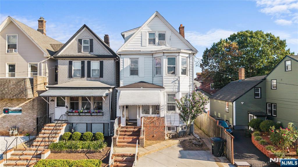 a front view of a residential apartment building with a yard
