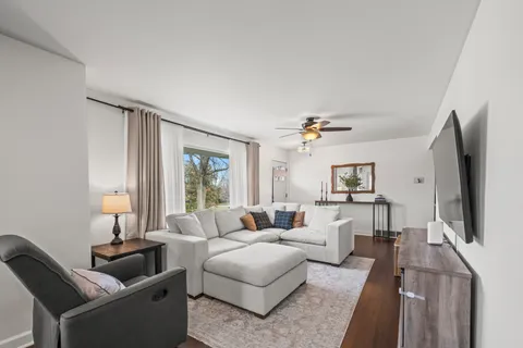 a view of a patio with couches chairs and a yard