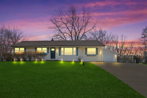 a view of a house with a yard and garage