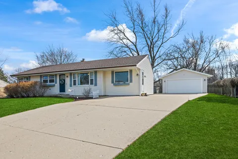 a kitchen with stainless steel appliances granite countertop a stove refrigerator sink and cabinets