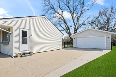 a kitchen with stainless steel appliances granite countertop a refrigerator a stove a sink dishwasher and a refrigerator with wooden floor