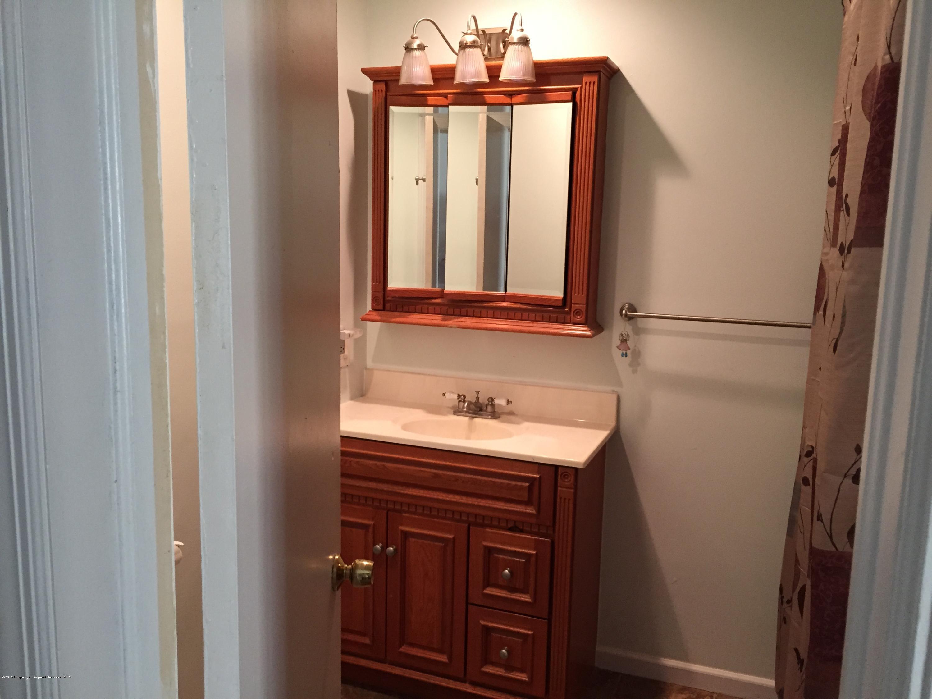 153 East 11th Street Rifle, CO 81650 - Photo 9 of 10 a bathroom with a sink a vanity and a mirror