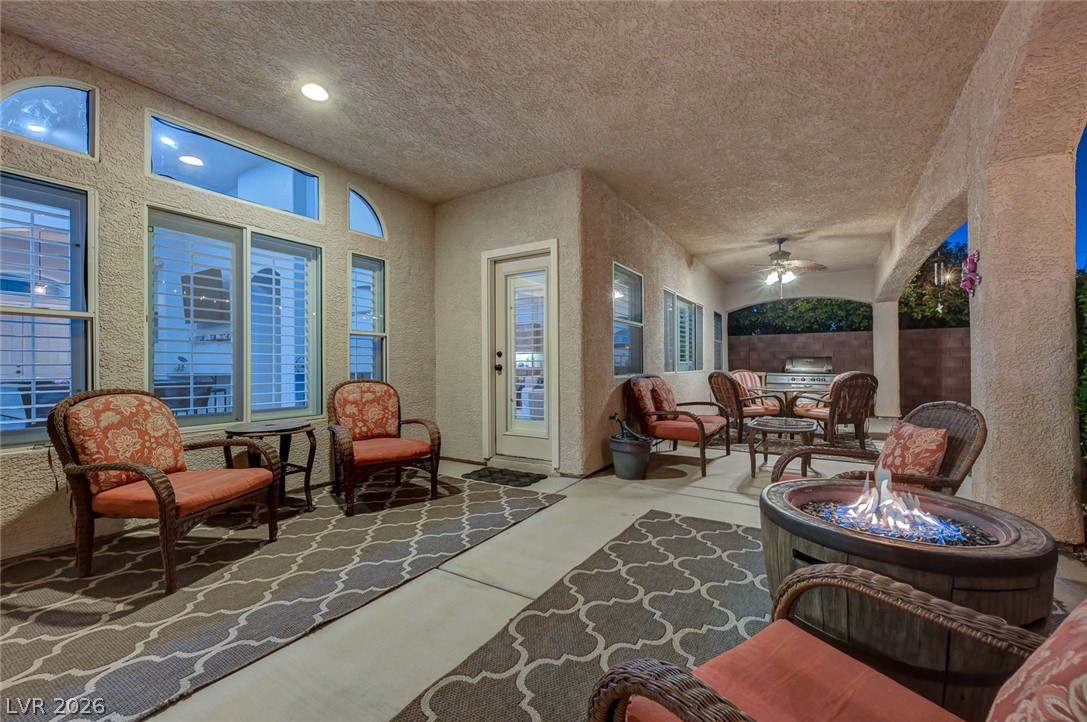 1604 Cattle Ranch Place Henderson, NV 89002 - Photo 96 of 99 An inviting covered patio featuring a built-in barbecue and a cozy fire pit.