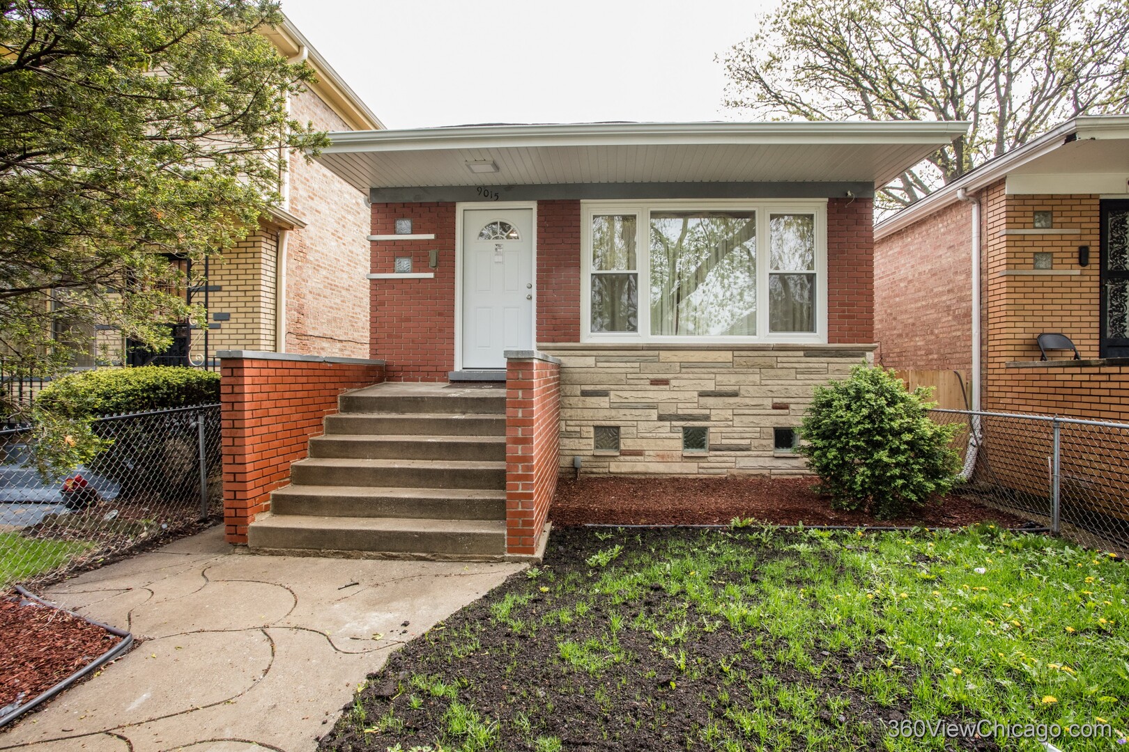 9015 South Carpenter Street Chicago, IL 60620 - Photo 1 of 23 a view of a house with potted plants and a bench