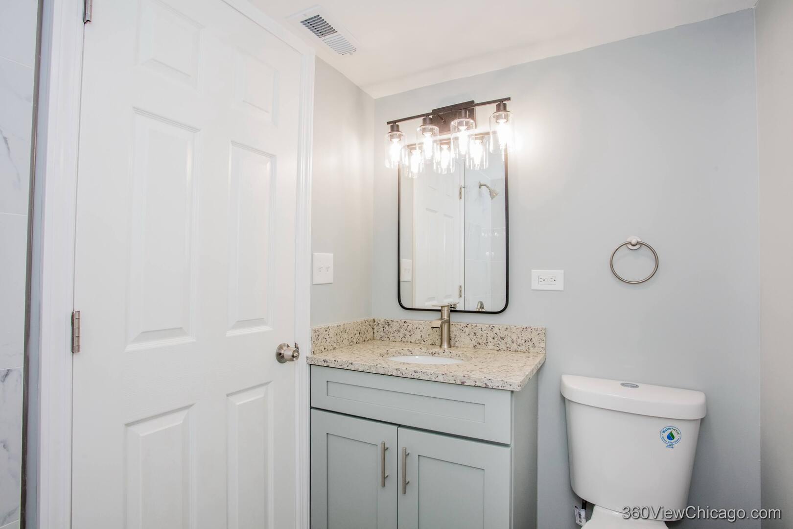9015 South Carpenter Street Chicago, IL 60620 - Photo 17 of 23 a bathroom with a toilet sink and mirror