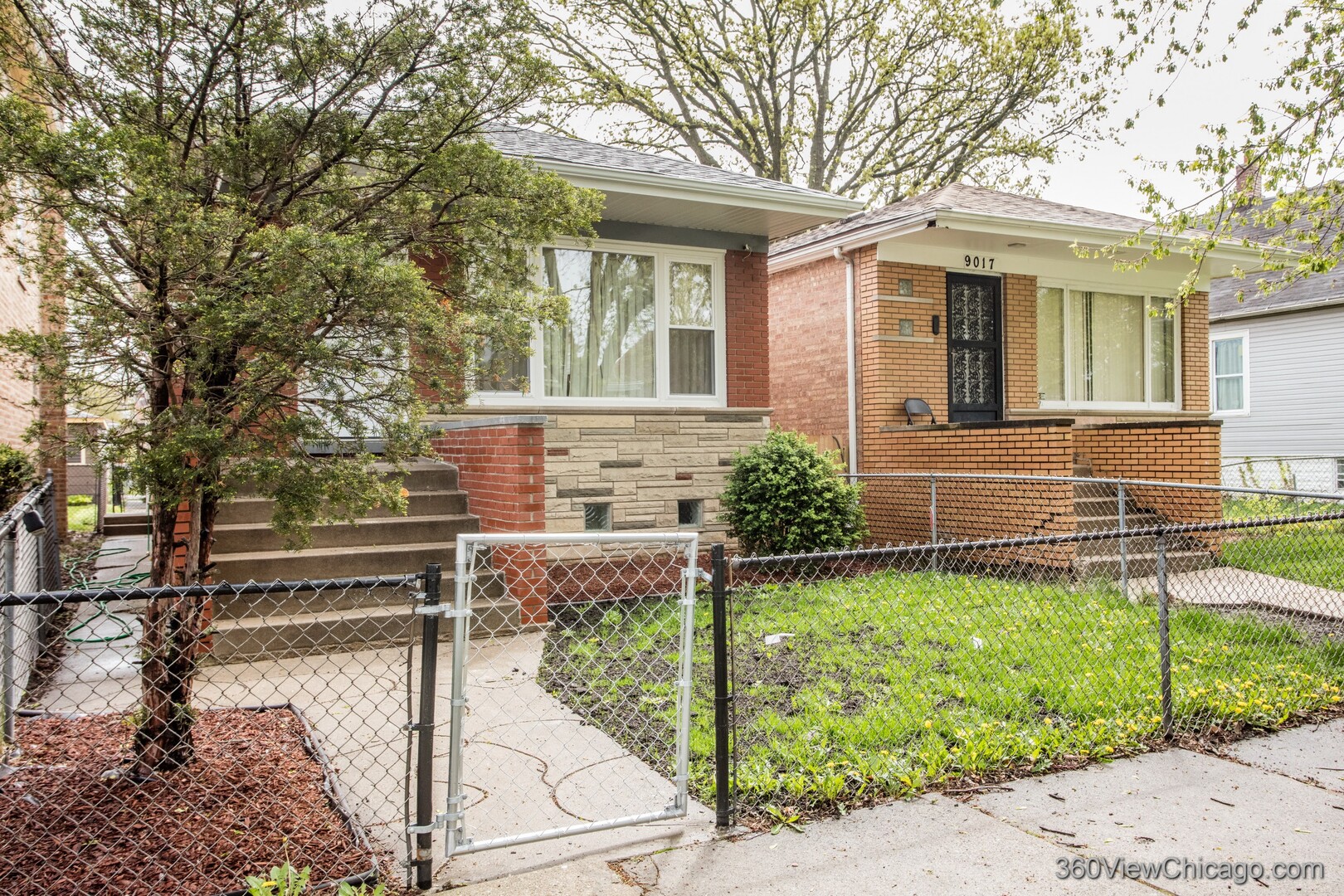 9015 South Carpenter Street Chicago, IL 60620 - Photo 2 of 23 a front view of a house with a yard