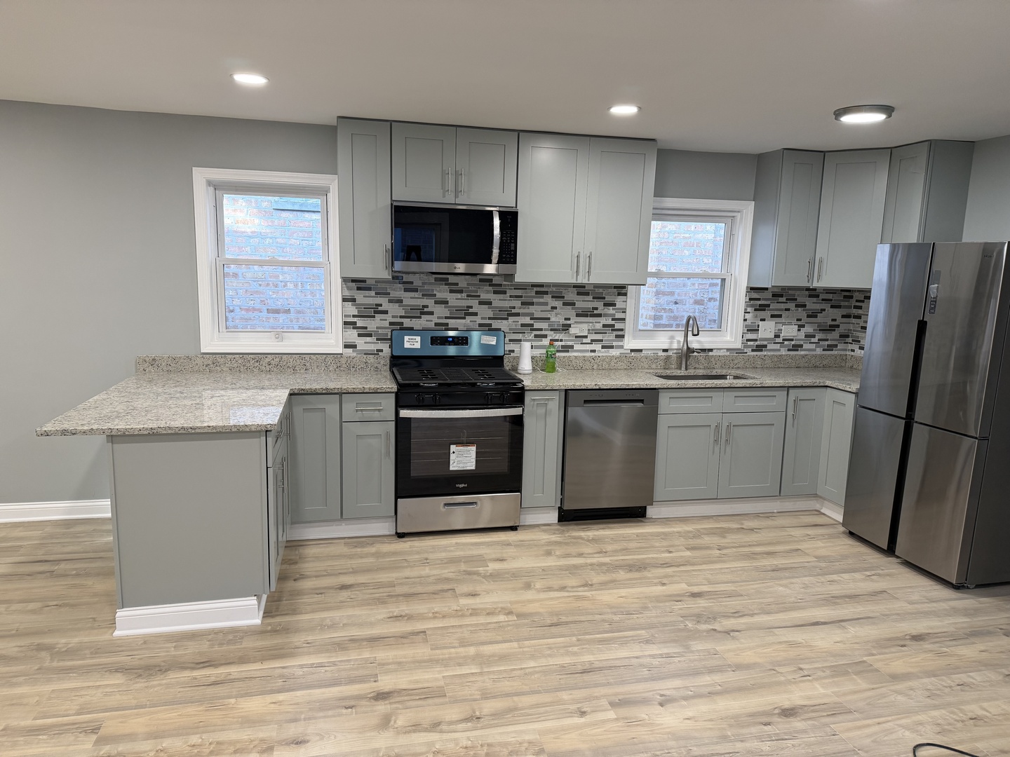 9015 South Carpenter Street Chicago, IL 60620 - Photo 5 of 23 a kitchen with stainless steel appliances granite countertop a stove top oven a sink and a refrigerator
