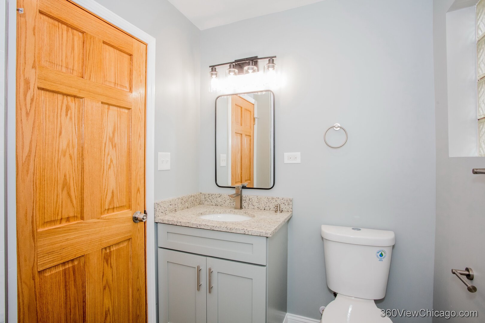 9015 South Carpenter Street Chicago, IL 60620 - Photo 8 of 23 a bathroom with a toilet sink and mirror