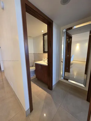 a bathroom with a shower and mirror