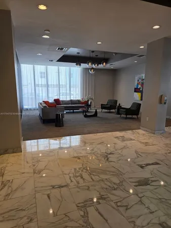 a kitchen with stainless steel appliances kitchen island granite countertop a sink and a stove