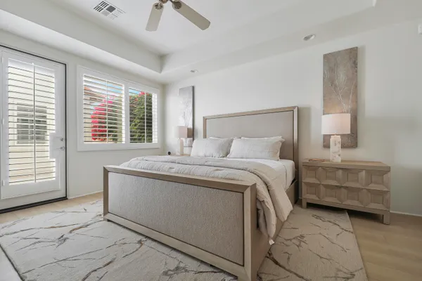a spacious bedroom with a bed and a cabinets