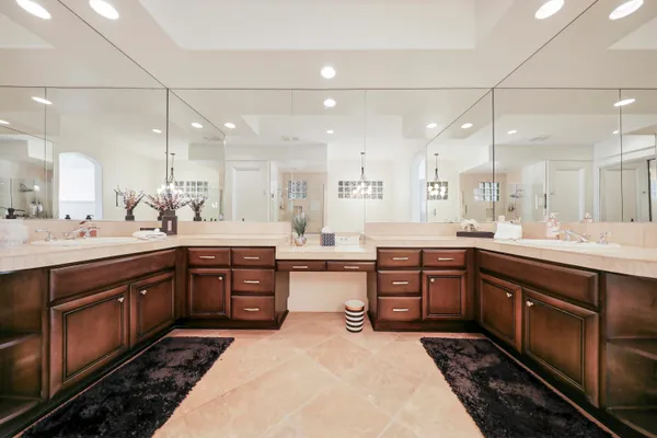 a large kitchen with kitchen island granite countertop a sink a counter space appliances and cabinets