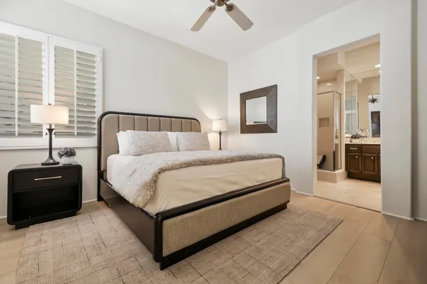 a bedroom with a bed window and a table