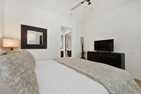 a bedroom with a bed and a flat screen tv