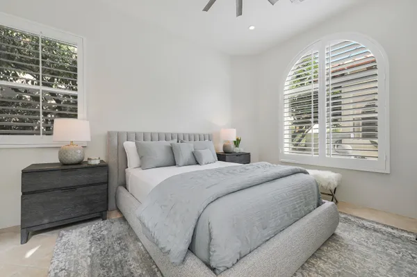 a bed sitting in a bedroom next to a window