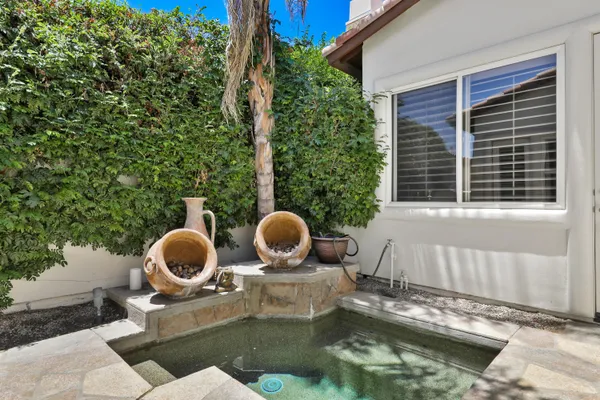 a backyard of a house with outdoor seating yard and mountain view in the background