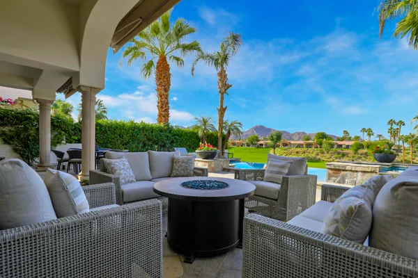 a view of a patio with couches chairs and a potted plant
