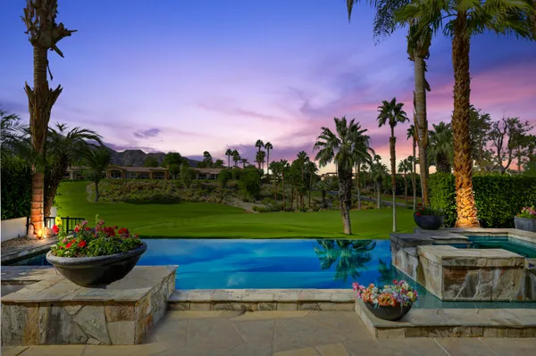 a view of a garden with an outdoor seating