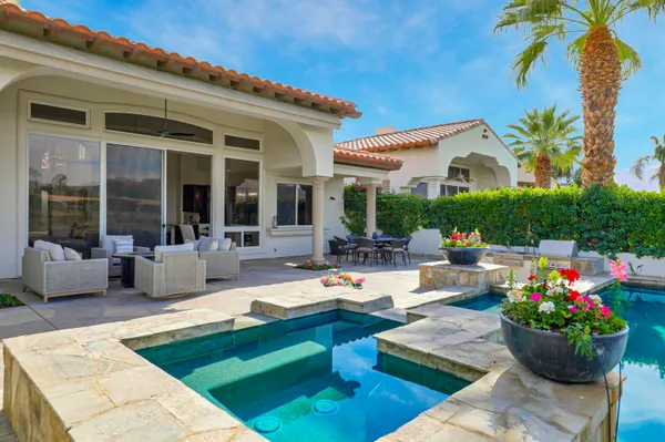 a swimming pool with outdoor seating and yard