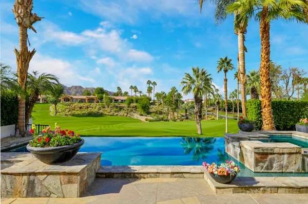 a view of a backyard with plants and outdoor seating