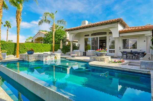 a view of a house with patio and a yard
