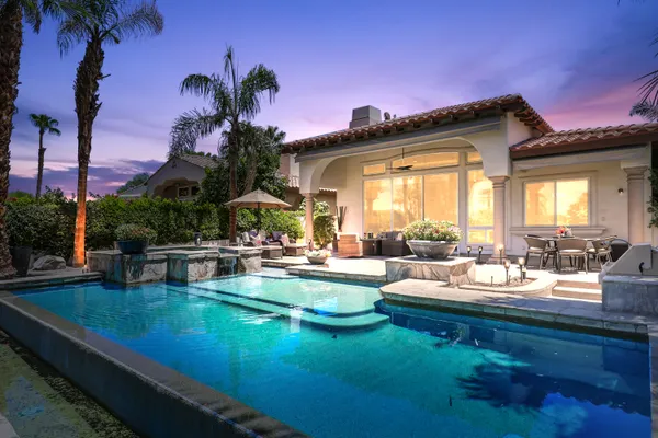 a view of a house with swimming pool outdoor seating