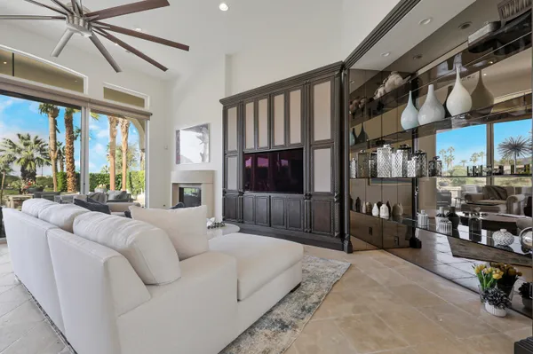 a large bedroom with a bed a couch and large window