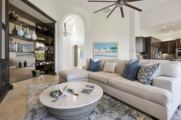 a living room with furniture and a chandelier