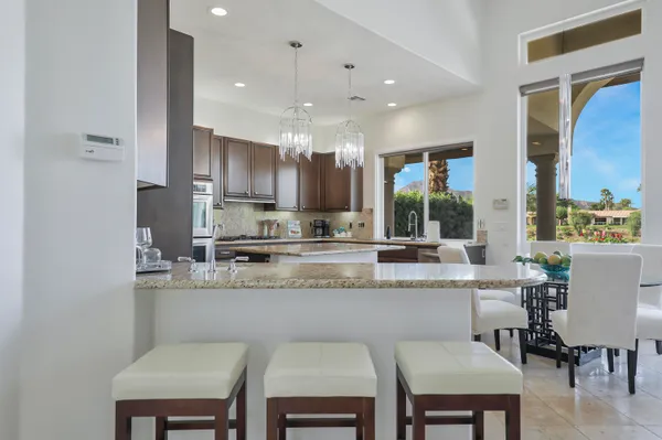 a large kitchen with a table and chairs