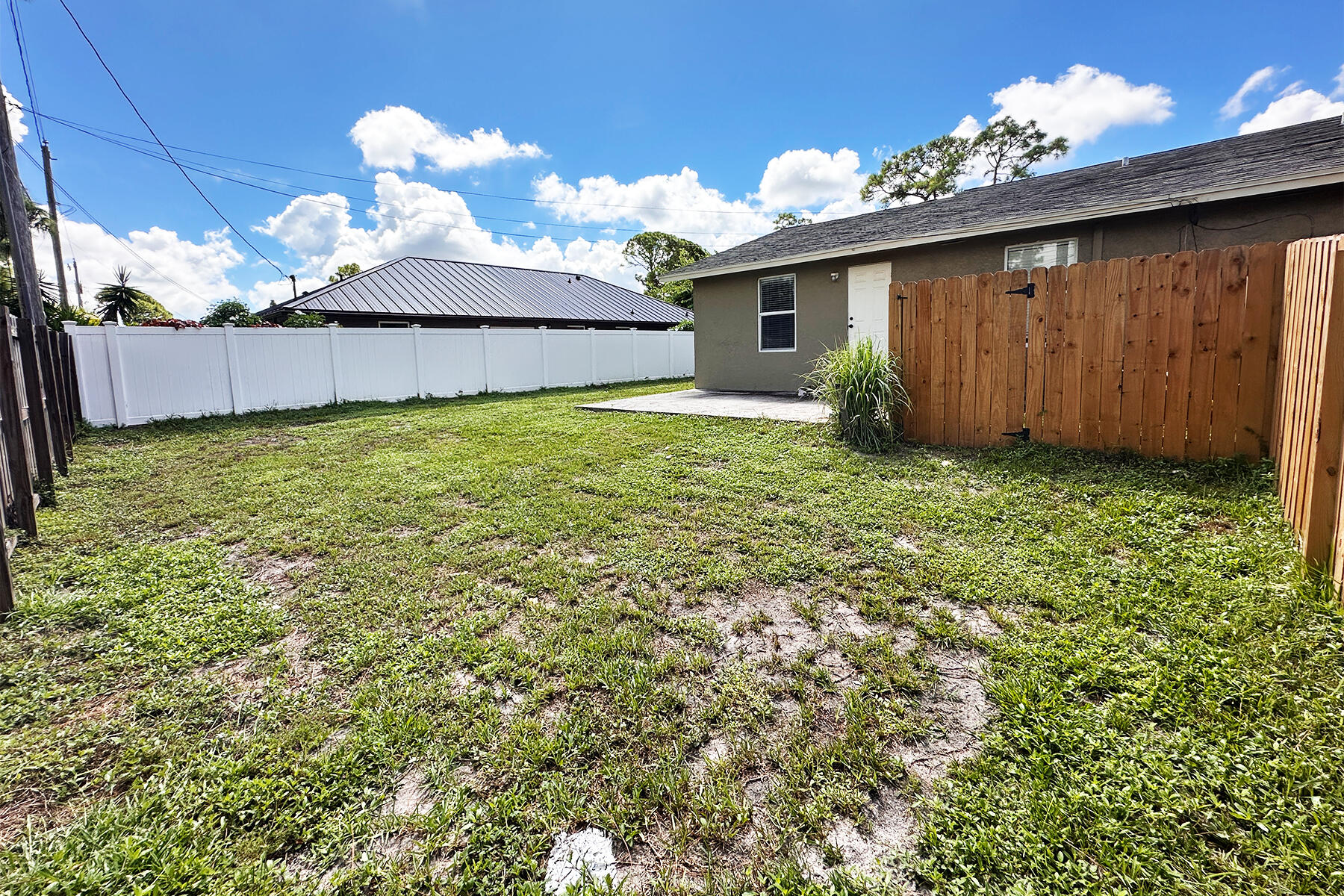 6171 Heather Street Jupiter, FL 33458 - Photo 18 of 22 a view of a backyard with a garden