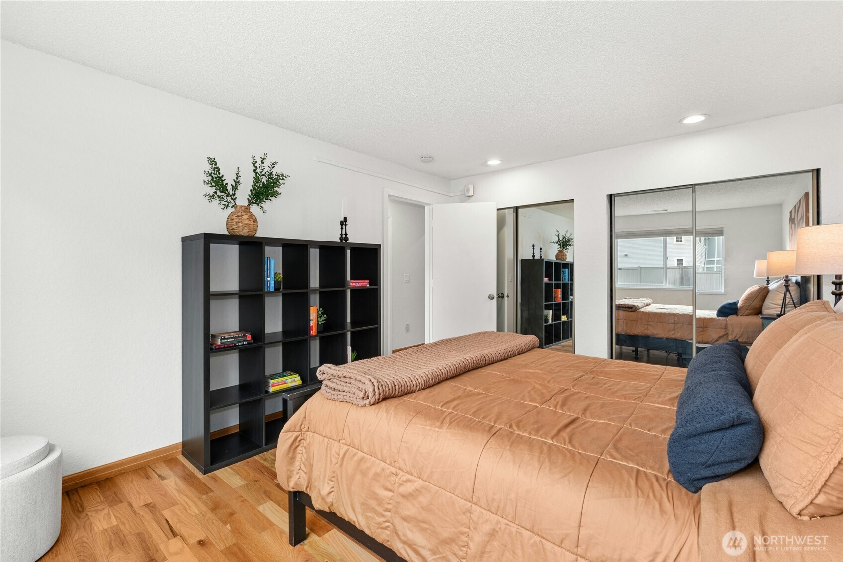 9523 Northeast 180th Street, Unit A102 Bothell, WA 98011 - Photo 16 of 29 a bedroom with a large bed and a closet