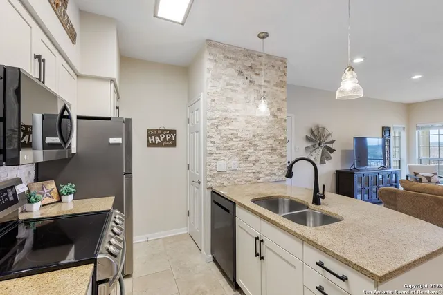 a kitchen with a sink cabinets and appliances