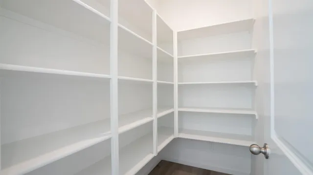 a view of walk in closet with empty racks