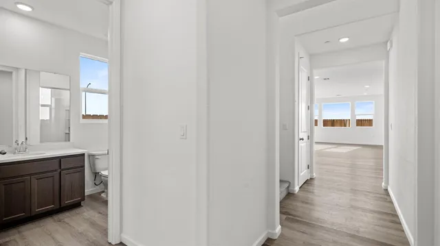 a view of a hallway with wooden floor