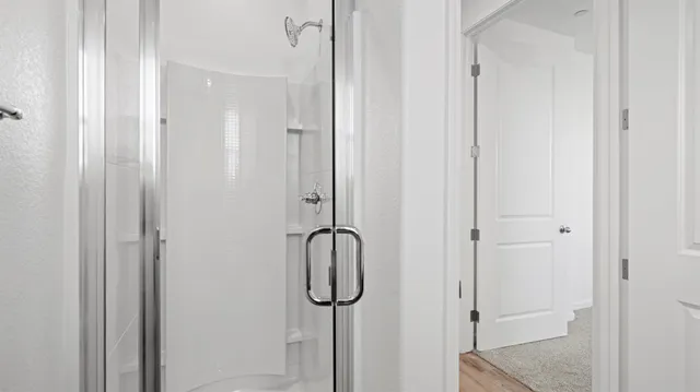 a bathroom with a glass shower door