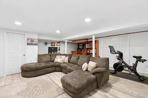 a living room with furniture a rug and white walls