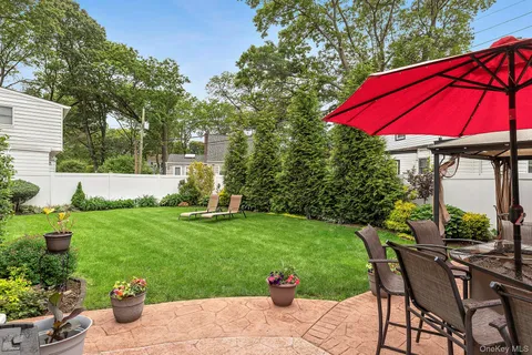 a view of a house with backyard sitting area and garden