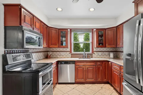 a kitchen that has a sink and a stove top oven