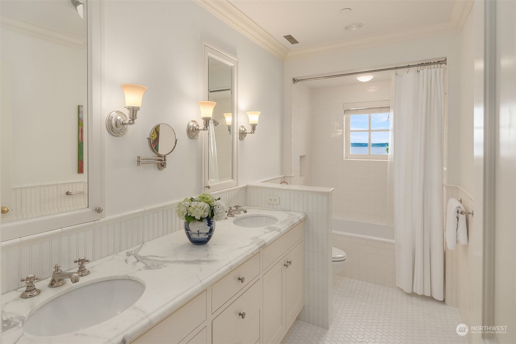 7002 North Mercer Way Mercer Island, WA 98040 - Photo 22 of 34 a bathroom with a double vanity sink and a mirror