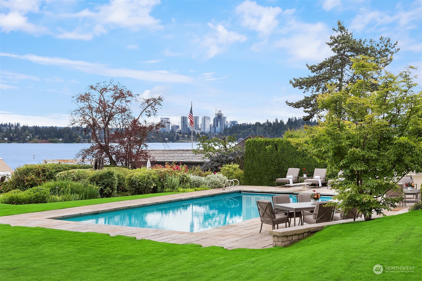 7002 North Mercer Way Mercer Island, WA 98040 - Photo 4 of 34 a view of a lake with a garden and houses