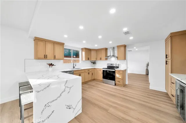 a kitchen with stainless steel appliances granite countertop a stove and cabinets
